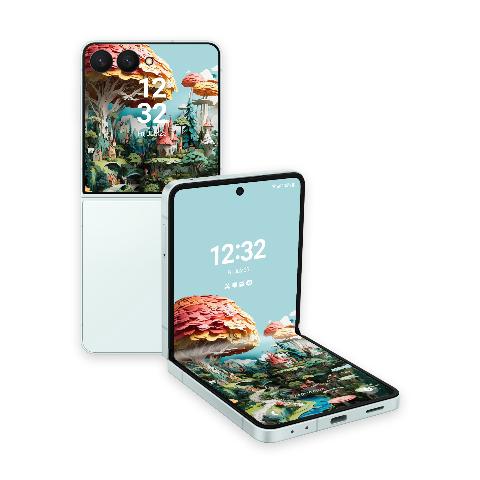 A white Samsung Galaxy Z Flip phone, unfolded, showcasing a detailed paper art scene with tiny castles, green hills, and mushroom trees against a blue sky, alongside another Z Flip phone shown from the back.