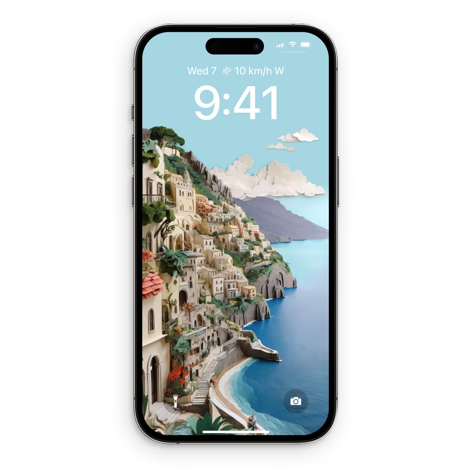 iPhone displaying a lock screen with a paper-cut illustration of the Amalfi Coast. Stacked pastel-colored buildings in cream, blush, and terracotta tones cascade down a clifftside toward a turquoise Mediterranean bay. The sky transitions from pale blue to deeper azure with soft white torn-paper clou